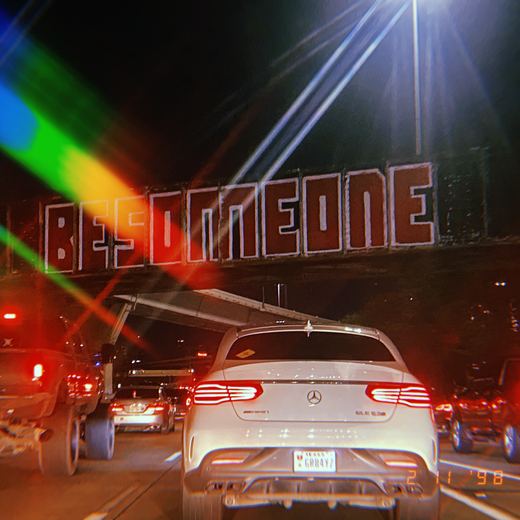 The Be Someone railway bridge sign above traffic in Houston